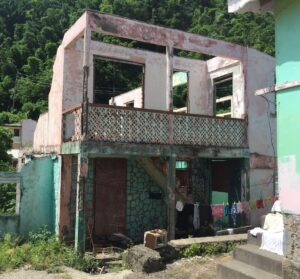 Spending on structural repairs is six times higher after a disaster. The study highlights the need for preventative action, when housing investments are more cost-effective. A damaged home in Dominica following Hurricane Maria in 2017. Image: Build Change