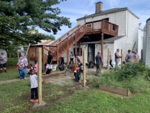 Pictured are volunteers fixing an unsafe fence with Habitat for Humanity